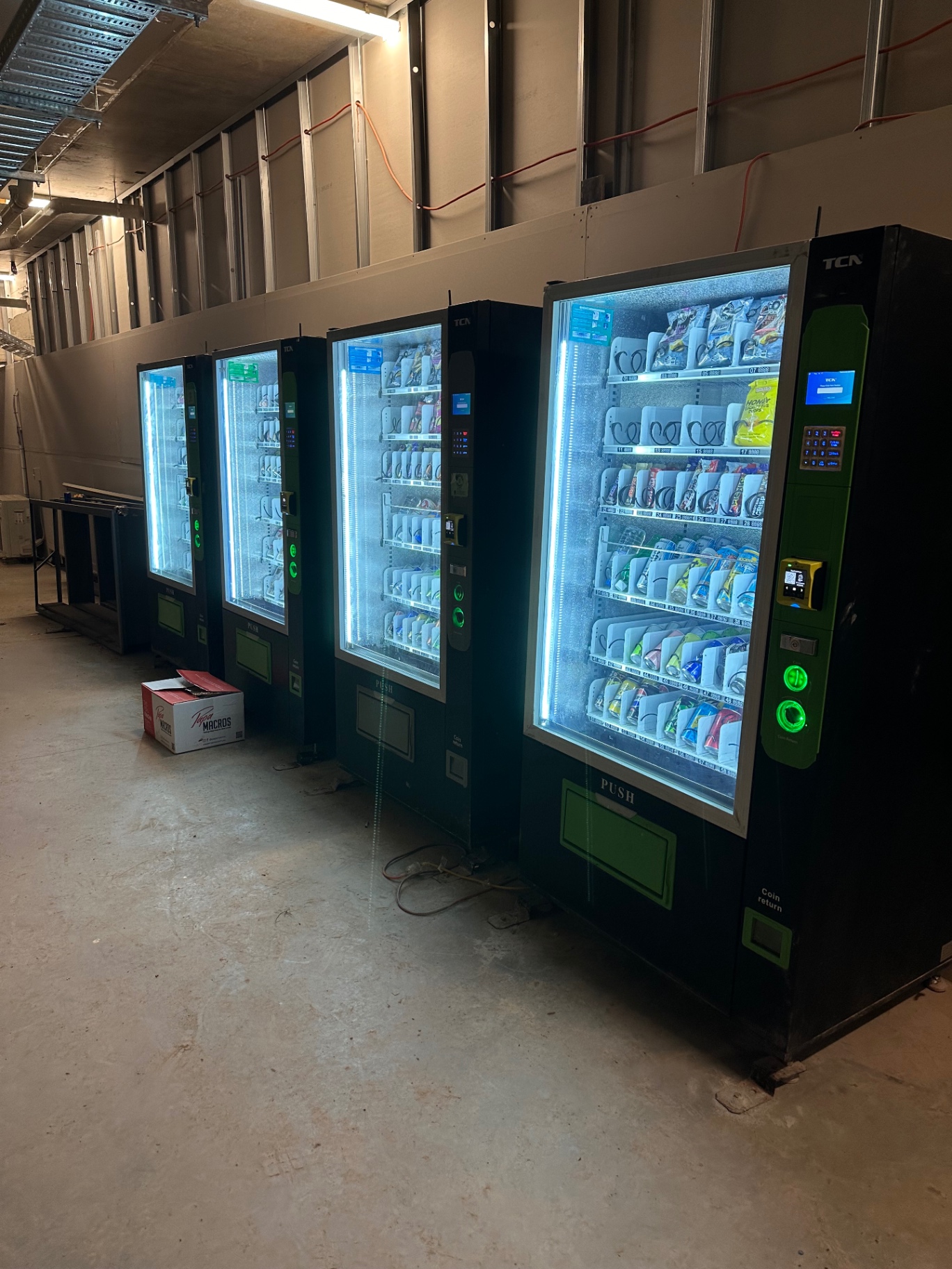 Multiple Vendor Bros. vending machines installed inside a construction site